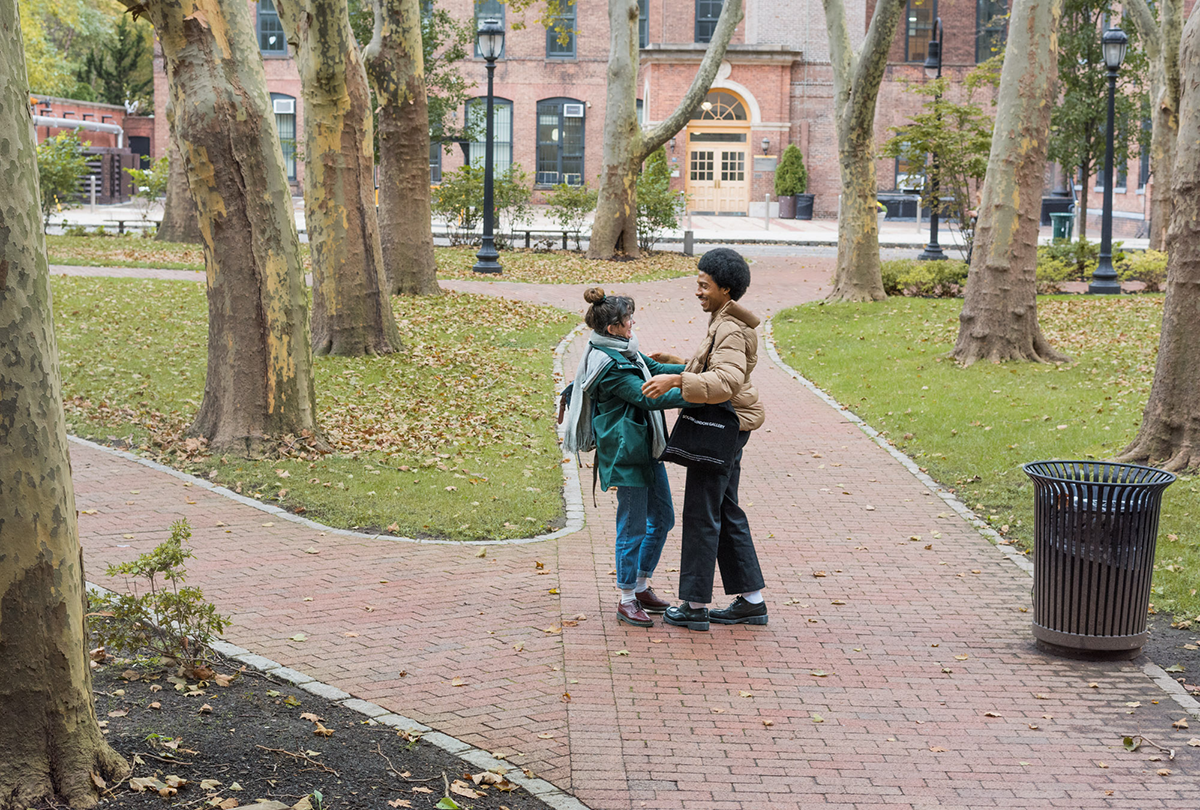 Two students embracing outside 